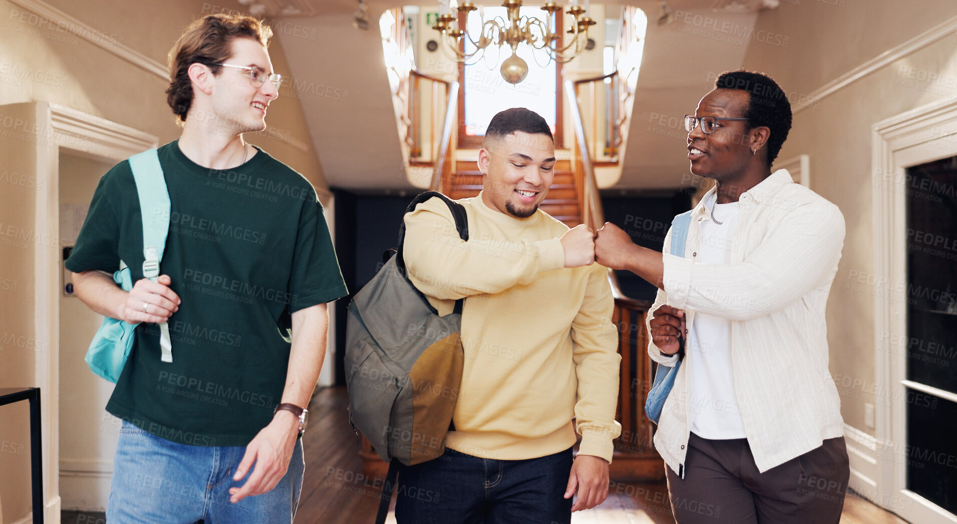 Buy stock photo Friends, walk and fist bump in university for greeting, conversation or learning together for degree. Happy, men and respect gesture in college with education, community and meeting people on campus.