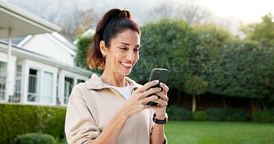 Buy stock photo Happy, woman and phone in backyard with social media, watch video and search blog for wellness tips. Mature person, smile and relax outdoor by home with tech, internet and browsing app for vitality.