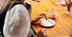 Person, hands and painting on ceramic for creativity, plate design and handcraft in workshop. Woman, artist and paintbrush on pottery for pattern process, craft project and creative hobby at table