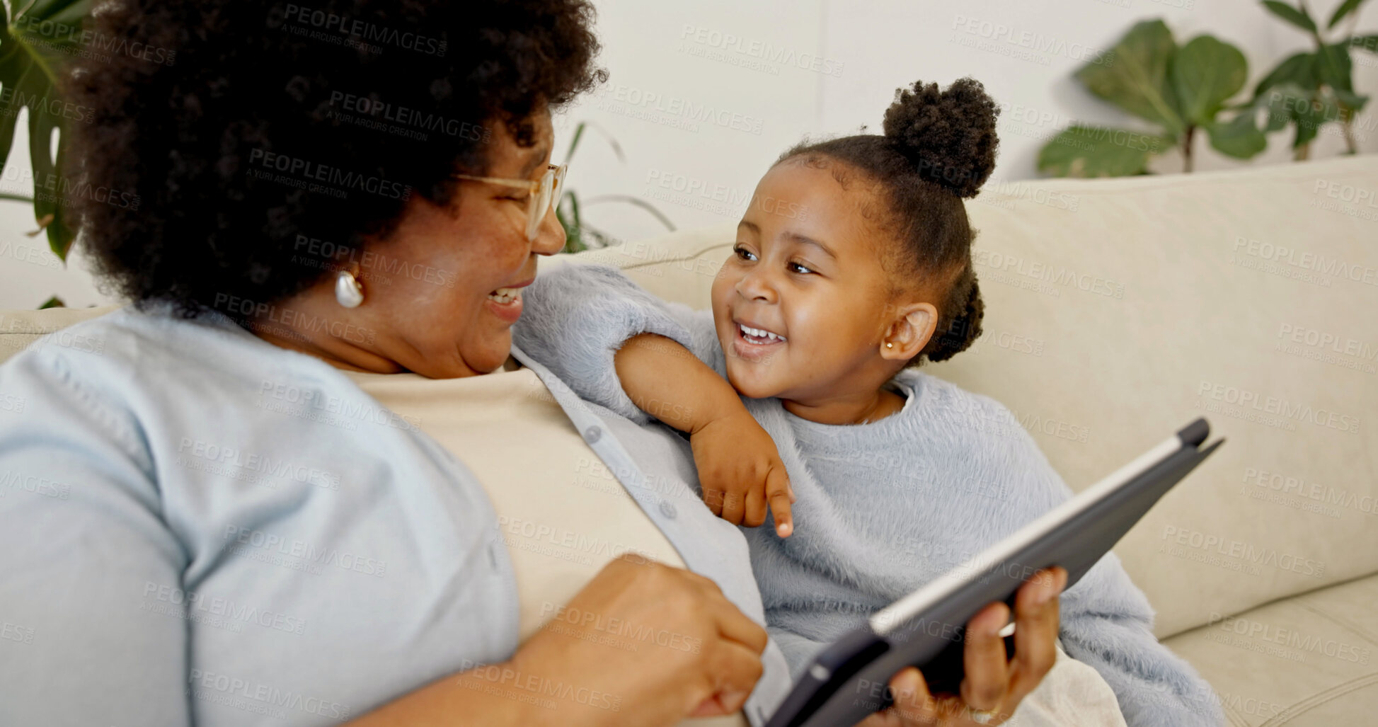 Buy stock photo Grandma, laughing and child with tablet in house, bonding and watching cartoons with subscription. Family, online and senior black woman with daughter, happy and streaming movie with tech in home