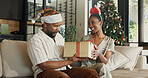Christmas, gift and black couple in home with surprise for festive celebration, holiday or bonding. Happy, man and woman with box, smile or present for December, Santa weekend or package in house