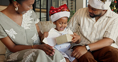 Buy stock photo Christmas, family and child with surprise box in home for festive celebration or December holiday. Mom, dad and happy girl with present, gift or package for Santa wish, weekend or bonding in house