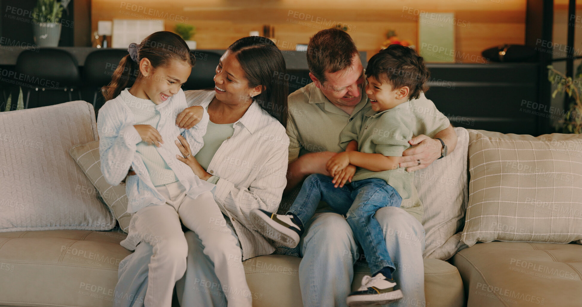 Buy stock photo Tickle, laugh and parents with children on sofa for bonding, playful relationship and connection. Happy, family and kids with mom, dad and playing for love, funny moment and relax in home on weekend