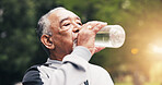 Senior, man and drinking water in nature for hydration, outdoor fitness or workout break in park. Active, elderly or male person with mineral liquid or bottle for thirst, sustainability or recovery