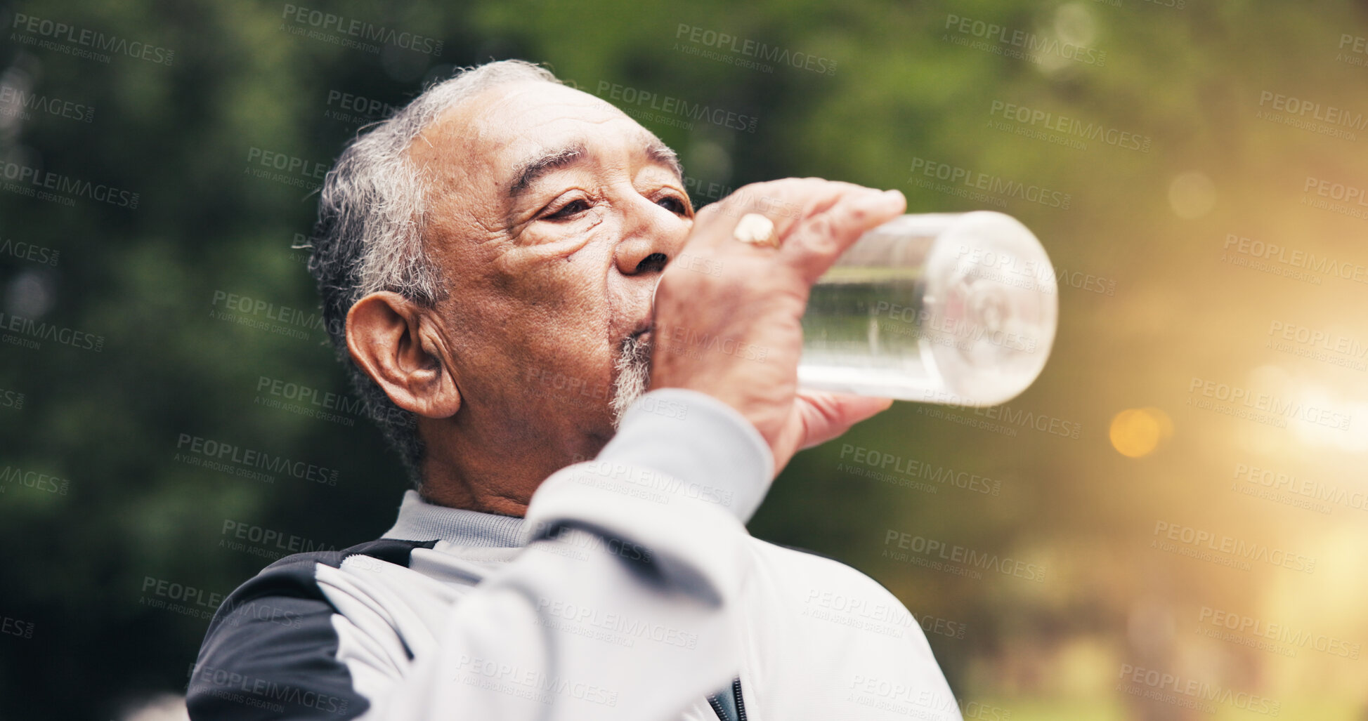 Buy stock photo Senior, man and drinking water in nature for hydration, outdoor fitness or workout break in park. Active, elderly or male person with mineral liquid or bottle for thirst, sustainability or recovery