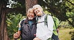 Hiking, happy and senior couple in nature for trekking, fitness and exercise for bonding and health. Marriage, mountain and man with woman hug for adventure, backpacking and travel outdoor for love