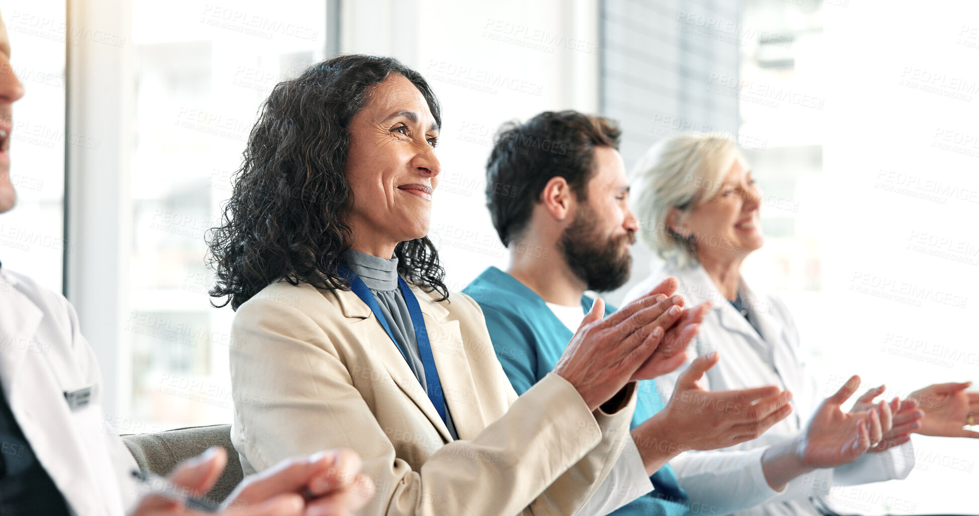 Buy stock photo Applause, team and woman in healthcare meeting with smile for success, achievement or breakthrough. Mature person, doctors and clapping at hospital with director for presentation or medical milestone
