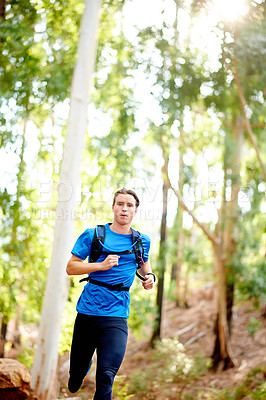 Buy stock photo Runner, fitness and man in forest for exercise, marathon training and cardio workout. Sports, nature and athlete in woods for wellness, healthy body and endurance for race, challenge and competition