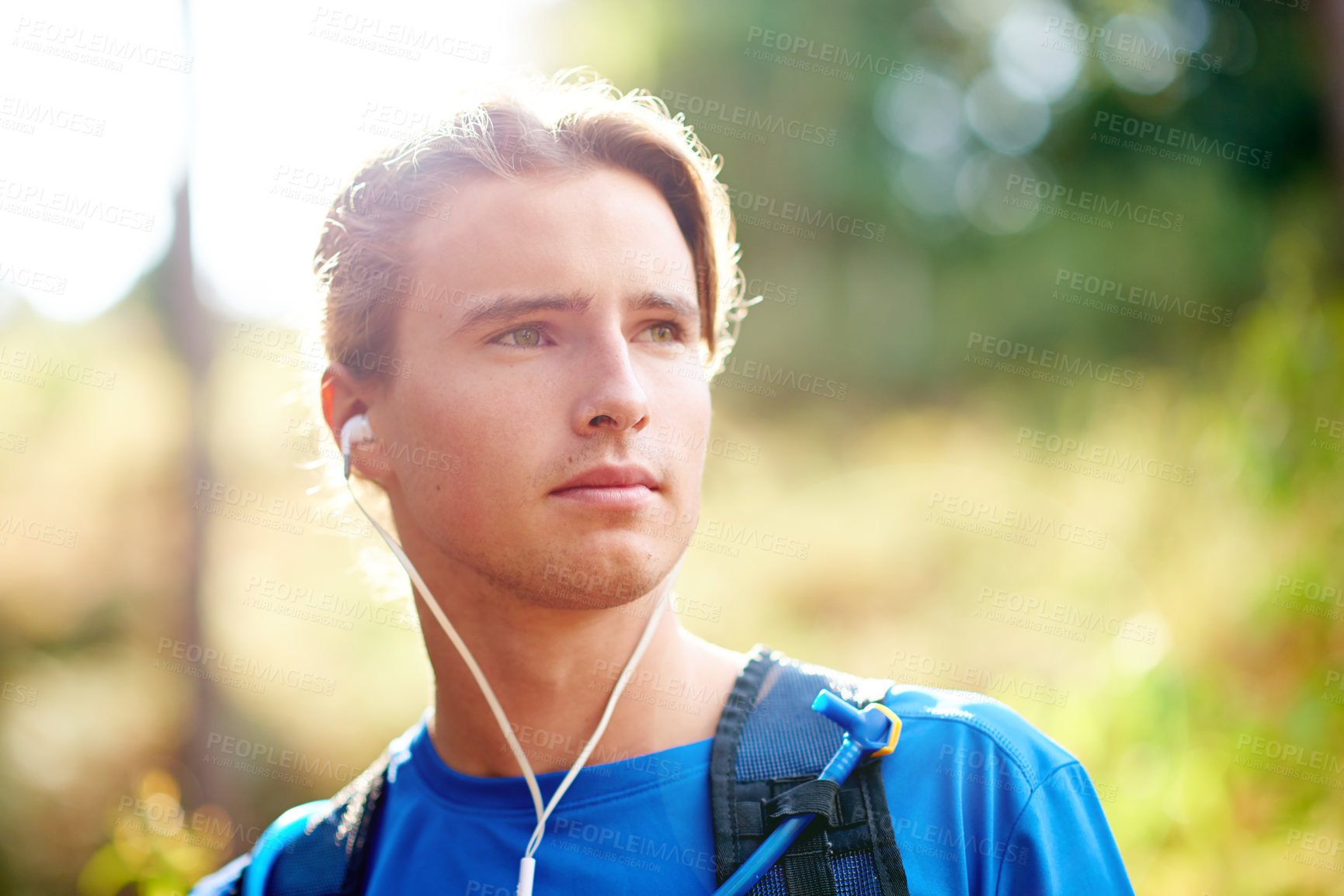 Buy stock photo Thinking, runner and man in woods, earphones and fitness with workout, listening to music and radio. Person, outdoor and athlete in forest, training and podcast for motivation, challenge and audio