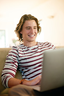 Buy stock photo Man, laptop and happy on sofa with streaming movies, relax and subscription for film at apartment. Person, computer and smile with media, video or post on social network in living room at house
