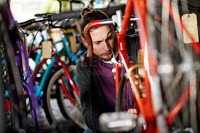 Buy stock photo Professional, repair and man with fixing bicycle in garage for maintenance on wheels, chain or frame. Small business, service and male mechanic with tightening mechanical part on bike at workshop.