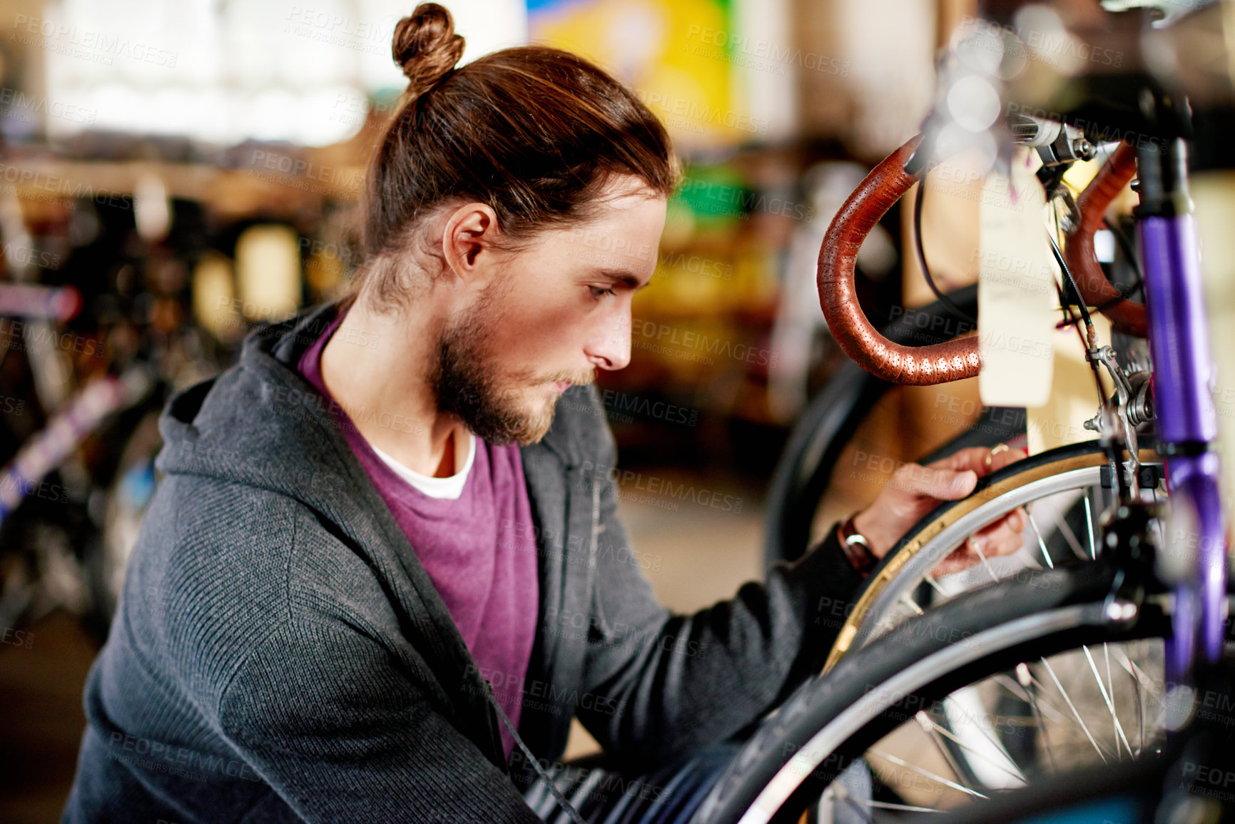Buy stock photo Bicycle, repair and man in shop, mechanic or maintenance of eco friendly transport and entrepreneur. Wheel, inspection and person with bike in garage, technician and restoration of tire in workshop