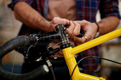 Buy stock photo Hands, tools and man fixing bicycle in garage for maintenance on wheels, chain or frame. Small business, repair and male mechanic with tightening mechanical part for improvement on bike at workshop.