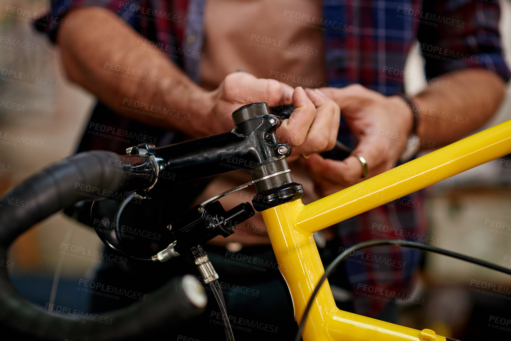 Buy stock photo Hands, tools and man fixing bicycle in garage for maintenance on wheels, chain or frame. Small business, repair and male mechanic with tightening mechanical part for improvement on bike at workshop.