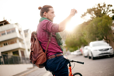 Buy stock photo Sightseeing, picture or man on bicycle in city for holiday vacation trip or tourism memory. Social media, explore or tourist in urban town with photograph for cycling adventure or travel experience