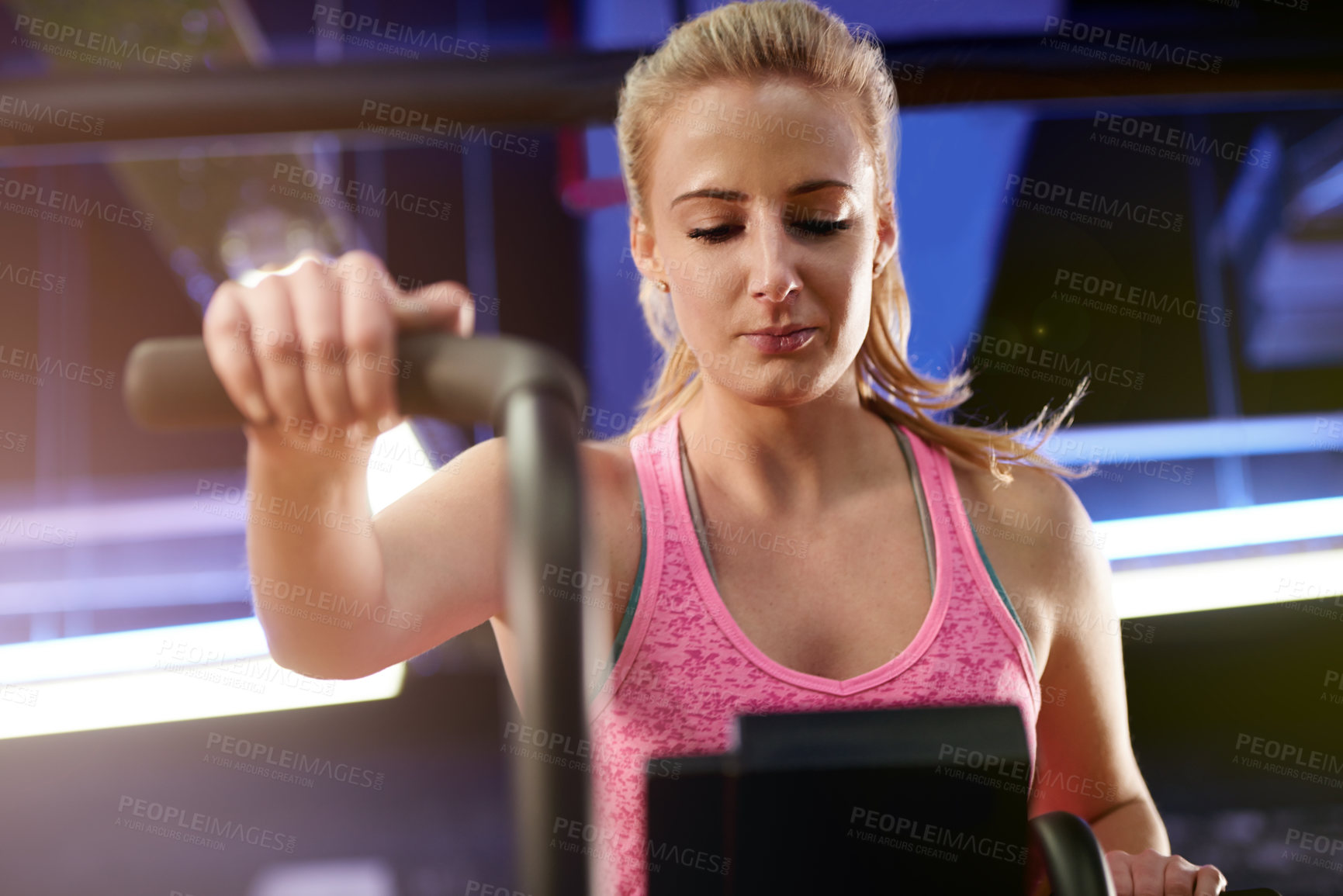 Buy stock photo Gym, below and woman on bike in training exercise for wellness, health and fitness. Athlete, active or female person on aerobic machine for endurance or power for workout, body or cycling in club
