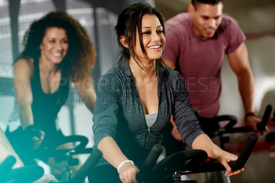Buy stock photo Happy, spin class or woman on cycling equipment in training for wellness, cardio health or fitness. Athlete, smile or active people on bicycle machine for workout, body or exercise in gym community