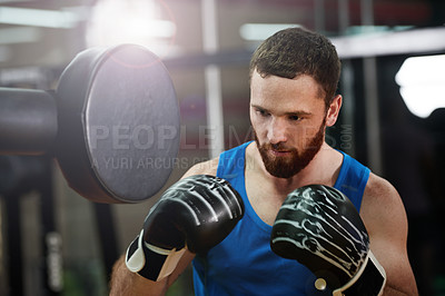 Buy stock photo Boxing, man and punch pad at gym for fight training, sparring and improve coordination. Fitness, technique and professional boxer in health club for conditioning, sports performance and endurance