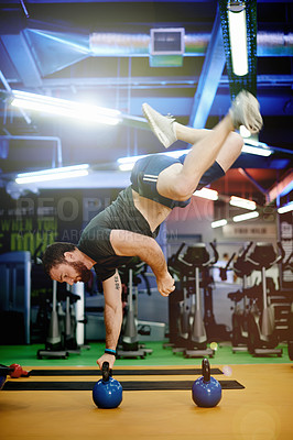 Buy stock photo Fitness, man and kettlebell handstand at gym for power training, balance and muscular endurance. Athlete, person and calisthenics with weights for functional exercise, core strength and night workout