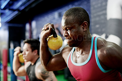 Buy stock photo Fitness class, power and man with kettlebell at gym for strength training, sweat or intense workout. Group, bodybuilder or weightlifting for endurance challenge, functional exercise and muscle growth