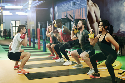 Buy stock photo Kettlebell, coaching and exercise with people at gym for bodybuilder bootcamp, training and workout. Personal trainer, weightlifting and fitness class with group of athletes in sports club for health