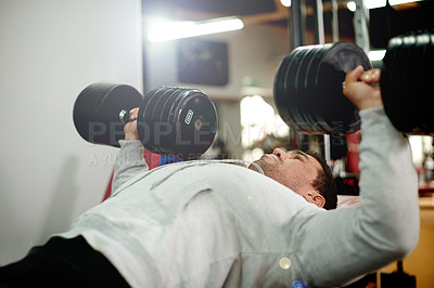 Buy stock photo Man, dumbbell and bench press at gym for exercise, chest muscle development or growth at fitness club. Person, bodybuilder and weightlifting for pecks, power or strong with workout at wellness center