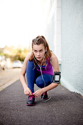Buy stock photo Girl, tying and laces with earphones for fitness start, running preparation and listening to music. Thinking, teenager and ready with shoes for exercise, sports workout and streaming podcast in city