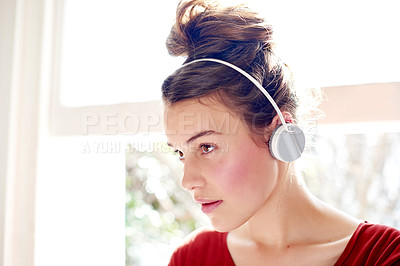 Buy stock photo Thinking, headphones and girl with music in home, streaming service or listening to sound of audiobook. Audio, technology and teenager with online playlist for pop on radio, song and podcast to relax