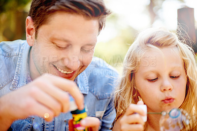 Buy stock photo Blowing bubbles, father and child in park for bonding, together and outdoor for fun. Soap toy, girl and man in garden with summer, holiday and daughter with care and play in nature for weekend