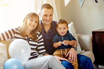 Buy stock photo Family, portrait and birthday with parents and child in living room for celebration, love and milestone at home. Happiness, together and man with woman and toddler for party or event with decorations