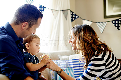 Buy stock photo Cupcake, birthday party and parents with baby in home for celebration together in living room. Happy, candle and boy toddler with mother and father for special event with decorations at house.