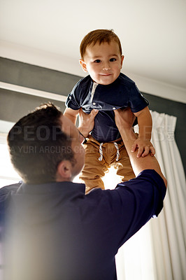 Buy stock photo Happy, portrait and father lifting baby in home with love, care and bonding together on weekend. Smile, family and man holding boy kid for playing airplane for growth in living room at house.