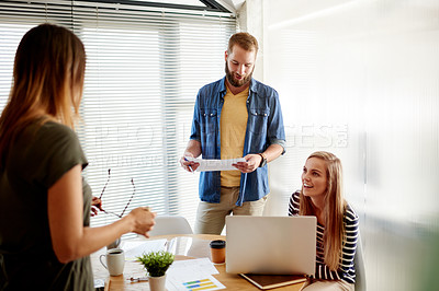Buy stock photo Conversation, documents and laptop with designer people in office together for creative brainstorming. Collaboration, computer and paperwork with employee team in workplace meeting for strategy