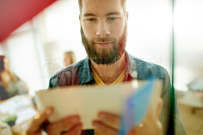 Buy stock photo Office, tablet and business man by glass with sticky notes for brainstorming, online project and planning. Creative worker, startup and person on digital tech for research, task agenda and website