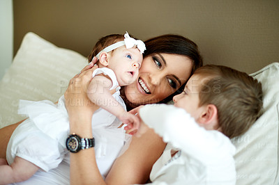 Buy stock photo Happy, children and mother in bedroom with care, love and bonding together for connection. Woman, son and daughter at home with trust, smile embrace and affectionate for special family memory.