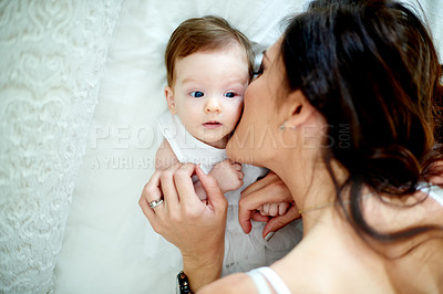 Buy stock photo Kiss, mom and baby in house on bed, motherhood and bonding together in nursery. Above, mothers day and happy family in bedroom with newborn, support and connection for childhood development.
