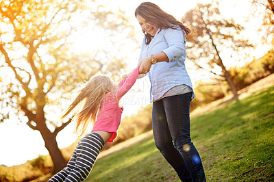 Buy stock photo Mom, spin girl and play at park with smile, bonding and child with love, flare and summer in nature. People, mother and daughter with games in garden, swing or family fun for laugh in New Zealand