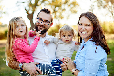 Buy stock photo Parents, children and happy in portrait at park with bonding, care and excited with flare in nature. Family, people and kids in garden, summer or smile outdoor with love for relationship in Spain