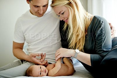 Buy stock photo Happy parents, baby and care on bed in home for love, touch or relax with bonding in morning. People, mother and father with infant child, connection or smile with newborn in nursery at family house
