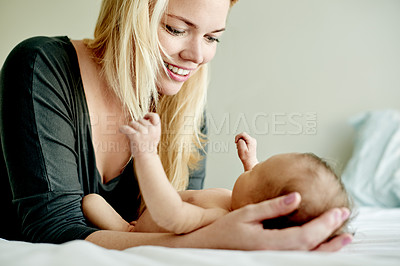 Buy stock photo Relax, happy and mother with baby on bed for bonding, care and family time in home together. Love, security and newborn child with mom in bedroom for support, safety and protection in apartment.