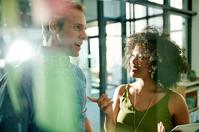 Buy stock photo Talk, team and business people planning by glass wall in office for brainstorming event themes. Meeting, tablet and collaboration for project idea with schedule, coordination or creative feedback