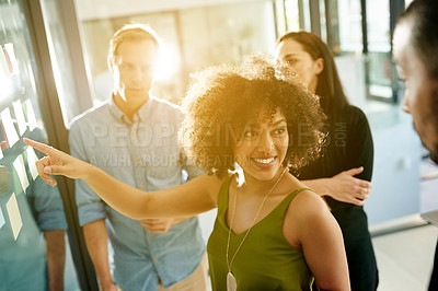 Buy stock photo Teamwork, scrum and pointing with business people and board for meeting, campaign progress and research. Sticky note, moodboard and project review with employees in office for schedule and lens flare