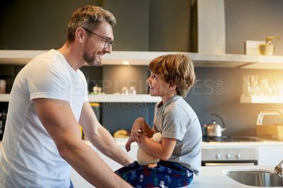 Buy stock photo Bonding, morning and father with son in kitchen of home together for routine or security. Conversation, love or smile with boy kid and single parent man speaking in apartment for child development