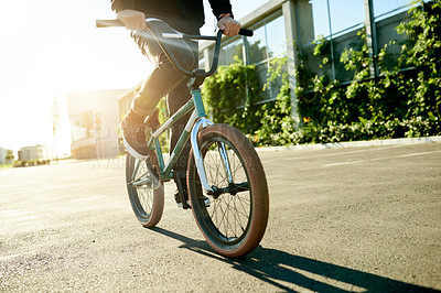 Buy stock photo BMX, legs and bicycle in city for exercise, eco friendly travel and cycling with hands. Person, riding bike and cyclist on road outdoor for fitness, sports and balance on urban street with flare