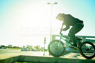 Buy stock photo BMX, man and bike in city for sports, urban challenge and exercise with space. Person, riding bicycle and cyclist on curb outdoor for fitness, extreme cycling and balance for stunt with flare