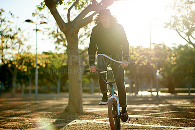 Buy stock photo BMX, man and bike at park for sports, eco friendly travel or exercise with trip. Person, riding bicycle and cyclist on road outdoor for fitness, cycling and sustainable transport in nature with flare