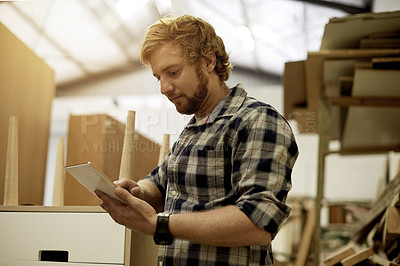 Buy stock photo Carpenter, woodwork and man with tablet in factory for stock management, client email or planning. Carpentry, worker and tech for furniture production, material order and reading supplier feedback