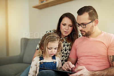 Buy stock photo Family, parents and daughter in home with tablet for playing games, streaming cartoon and bonding. Tech, child or people in apartment with digital kids app, watching video or online entertainment.