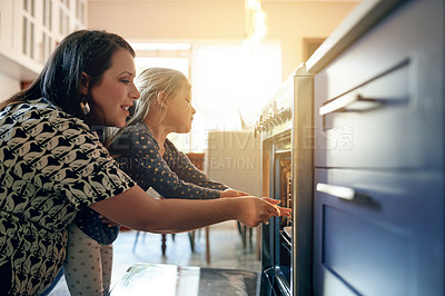 Buy stock photo Oven, baking and support with mother and daughter in kitchen for cupcake, cooking and learning. Help, food and teaching with woman and child in family home for dessert, bonding and love together