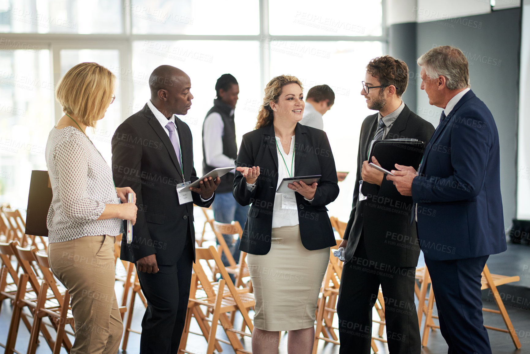 Buy stock photo Business woman, tablet and networking at conference with group, introduction or discussion at meeting. People, professional chat and tech with app, smile or communication at international convention